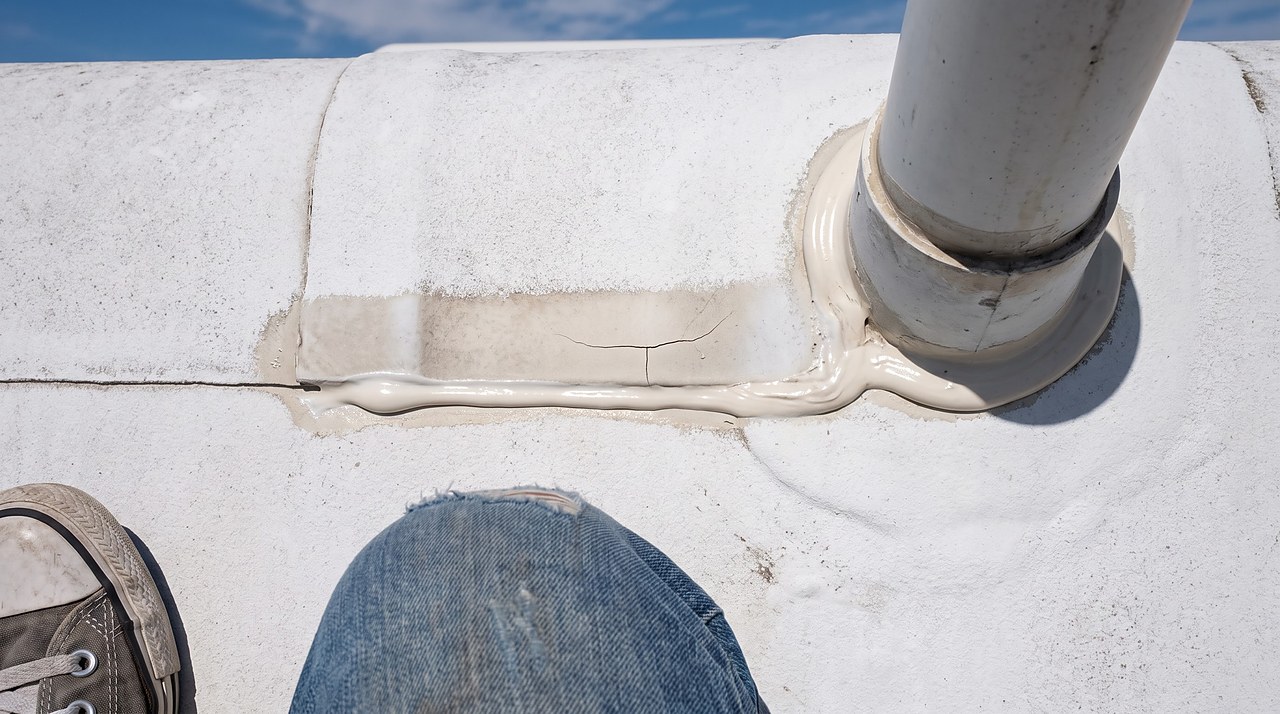 hairline crack in roof sealant along a vent pipe seam during a seasonal inspection
