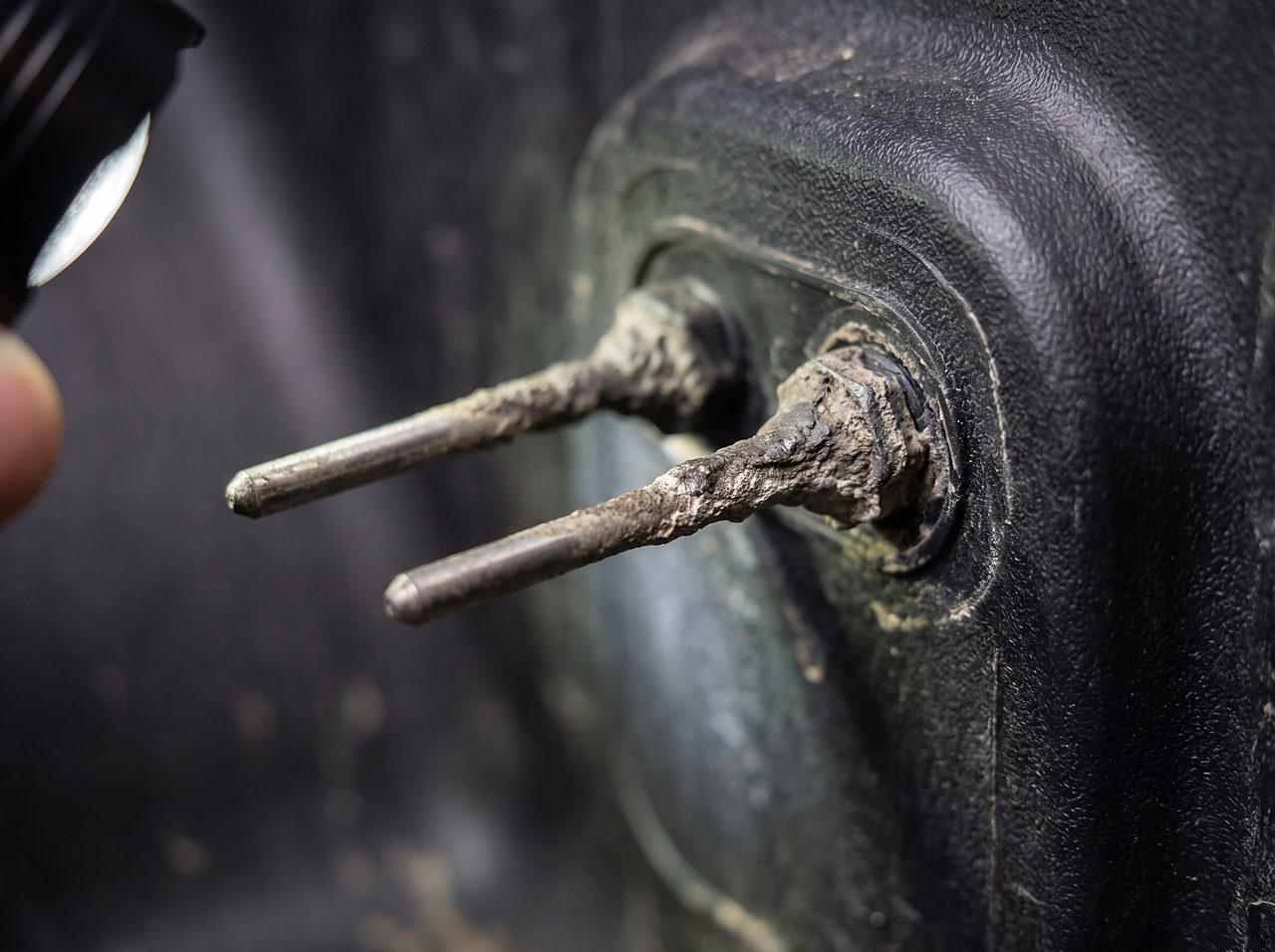 close-up of holding tank sensor probes coated in dried residue film