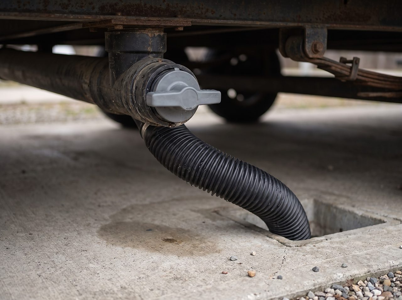 closed gray waste valve and sewer hose connection at an RV dump station