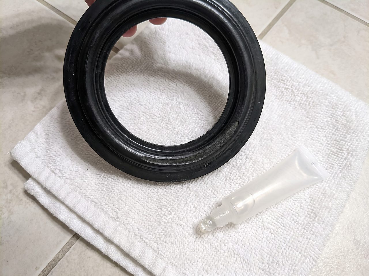 worn black rubber toilet seal gasket showing a flattened wear groove